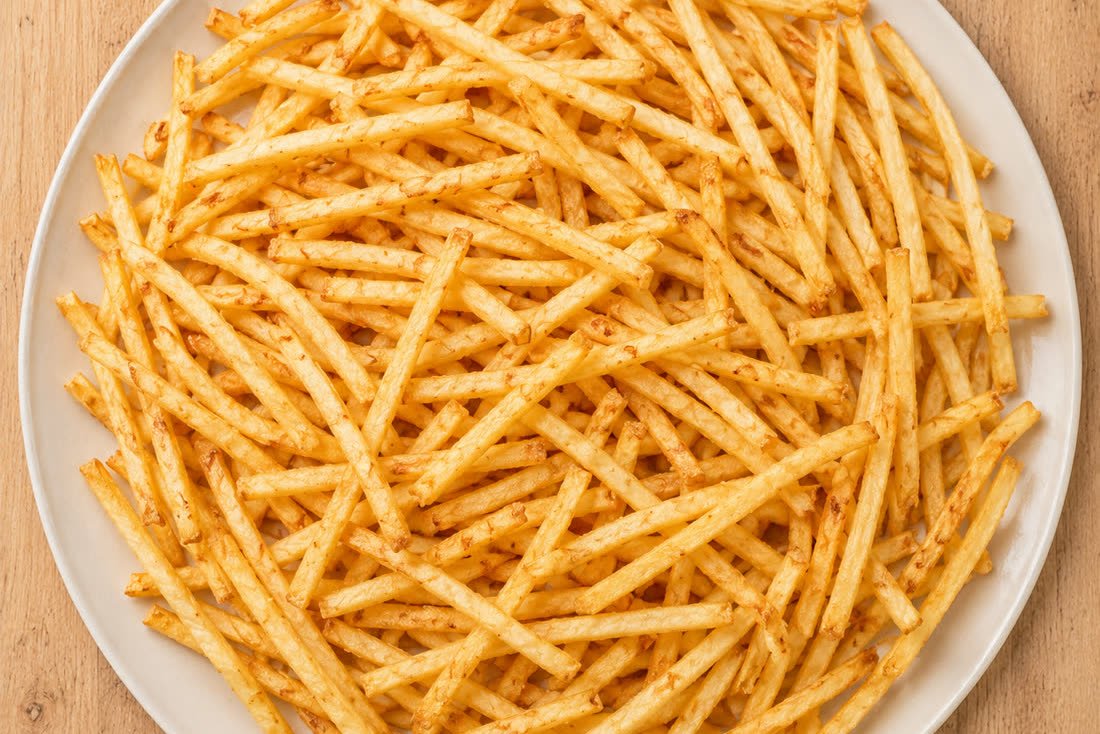 A plate piled with golden Aladey cassava fries